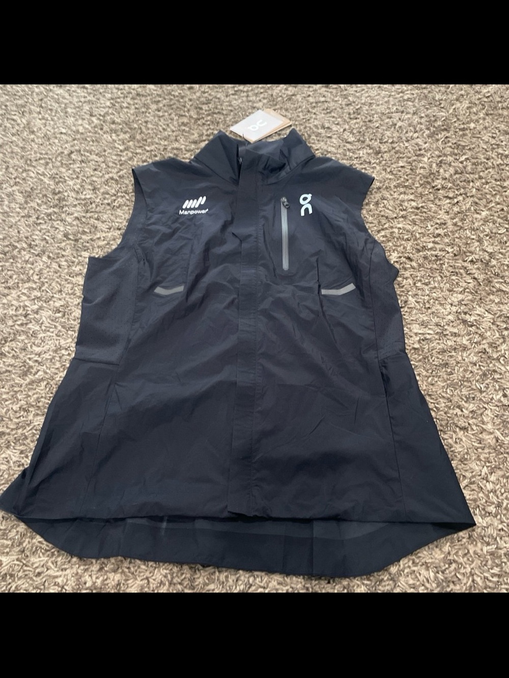 On NWT running weather vest, black women’s medium